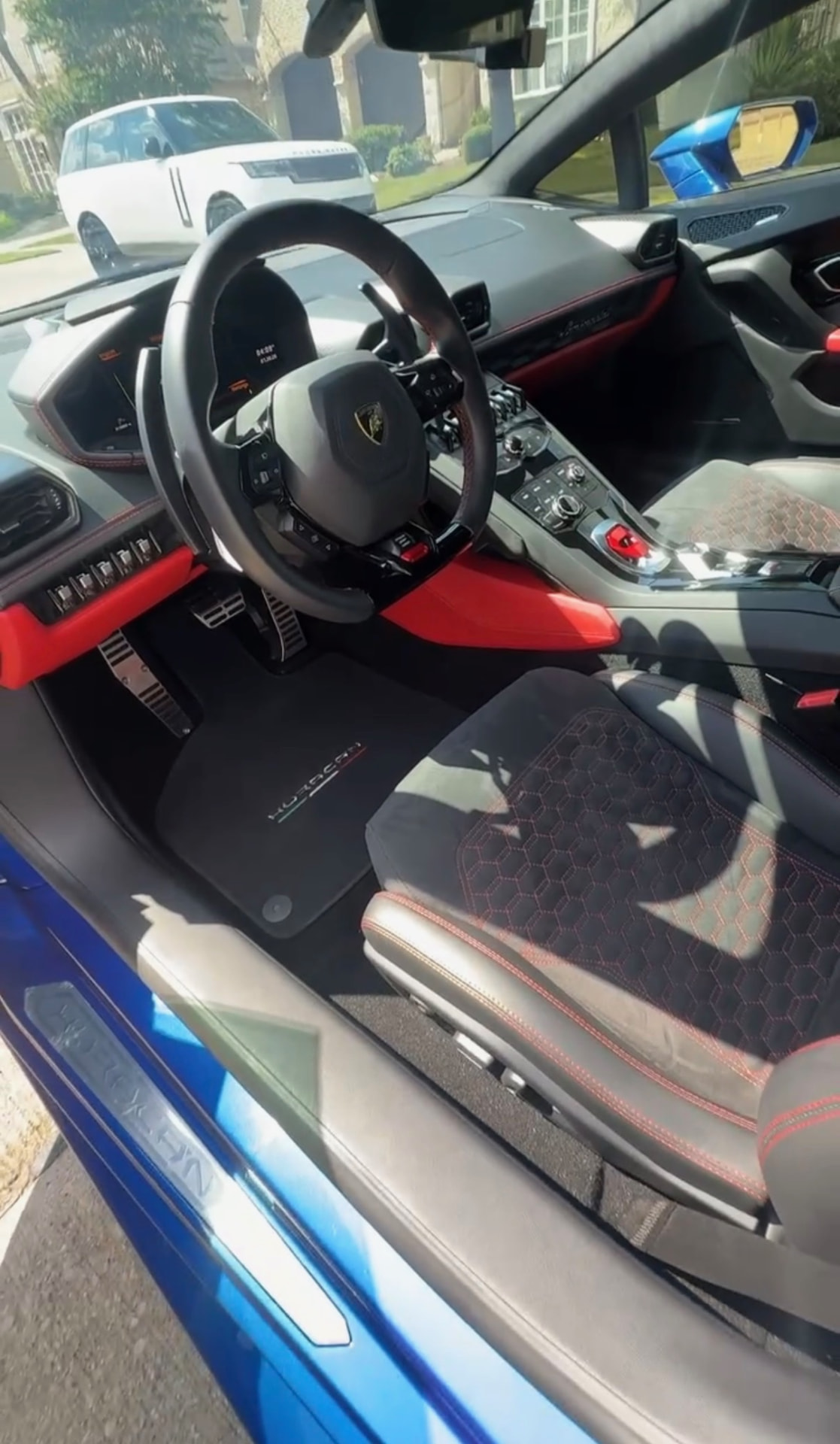 Blue Lamborghini Huracan interior with black and red Alcantara seats detailed by Grandlux Detailing in Frisco, TX