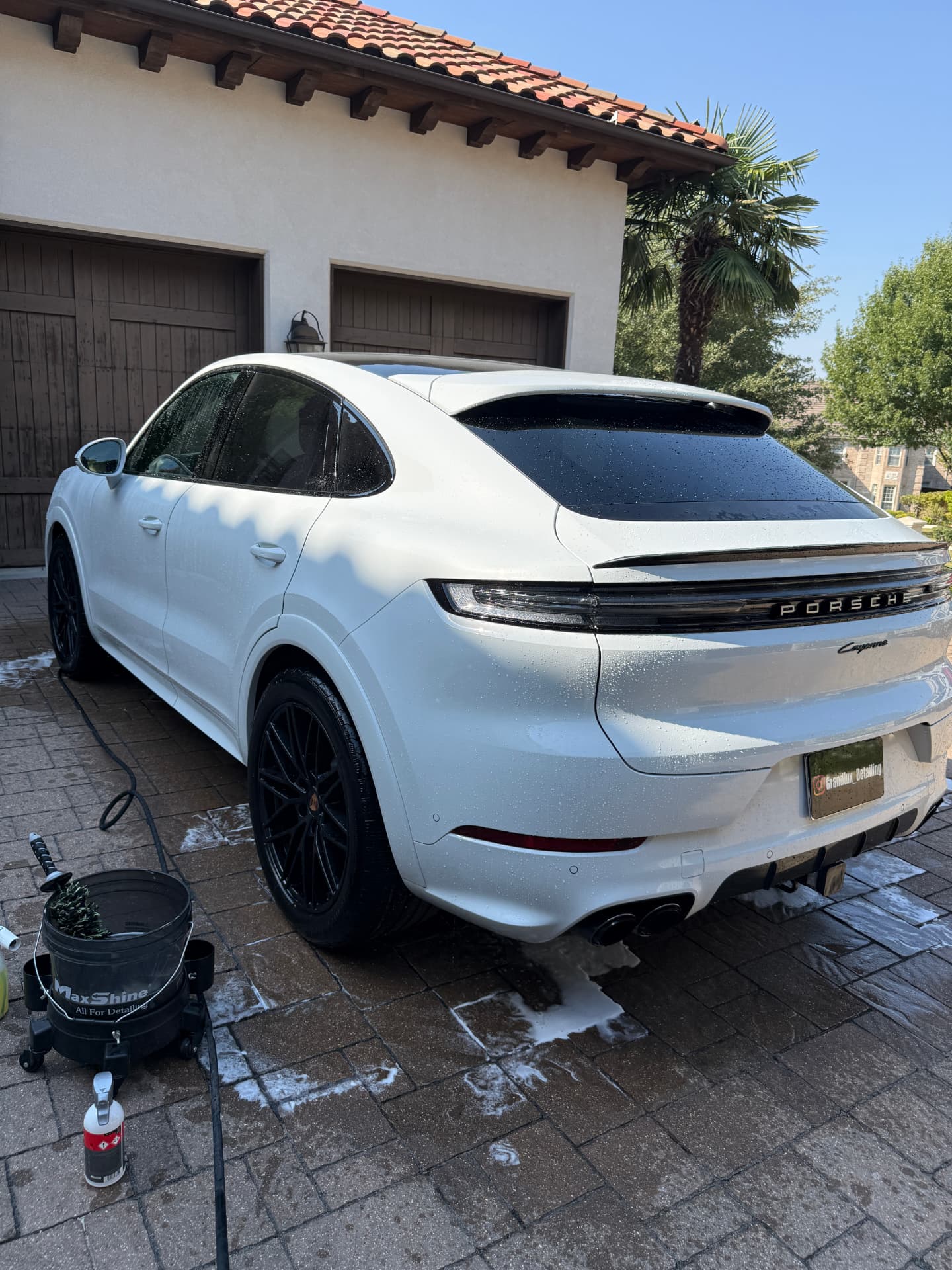 White Porsche Cayenne Coupe being foam washed in a Frisco TX driveway during a Grandlux Detailing mobile detail