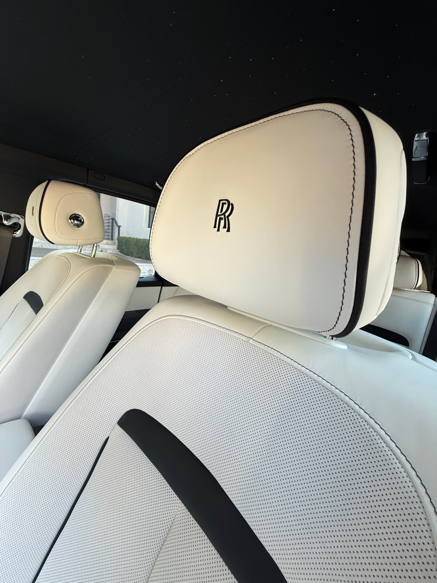 Immaculate white leather Rolls-Royce interior with starlight headliner after a Grandlux mobile interior detailing service in Frisco, TX